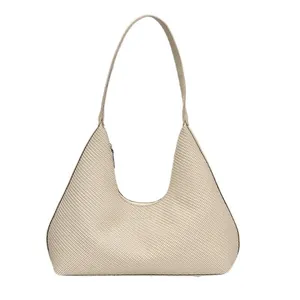 Minimalist beige woven leather hobo bag with a sleek trapezoid silhouette and shoulder strap