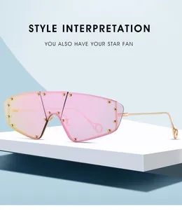Detail of oversized shield sunglasses with gradient pink lenses and gold rivet accents