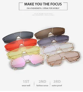 Collection of oversized shield sunglasses with colorful lenses and gold rivet detailing
