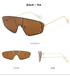 Detail view of gold metal frame sunglasses with tea lenses and decorative metal rivets