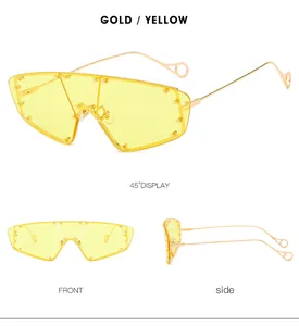 Detailed views of gold metal frame shield sunglasses with yellow lenses and rivet accents
