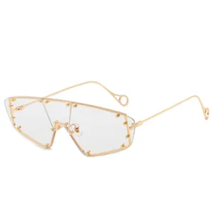 Futuristic gold metal frame sunglasses with rimless flat top lens and stud detailing