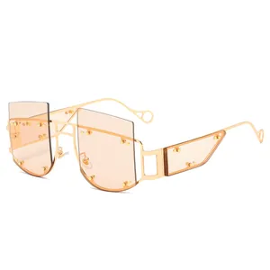 Frameless oversized geometric sunglasses with gold metal frame and orange tinted lenses
