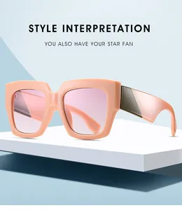 Detailed view of the wide peach resin temples and pink gradient lenses on square sunglasses