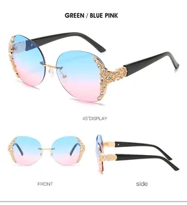 Detail of round rimless sunglasses with blue-pink gradient lenses and leaf rhinestone accents