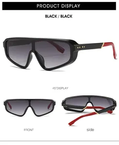 Détail de lunettes de soleil plates avec branches rouge et noir et accents en métal doré