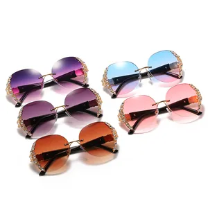Retro oversized round rimless sunglasses for women with rhinestone accents and gradient lenses