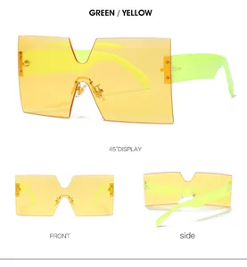 Detailed views of oversized square sunglasses with yellow lenses and green frames