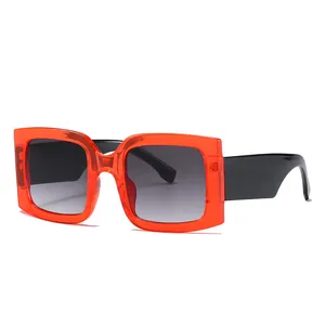 Fashionable square sunglasses with transparent orange frames and black wide temples