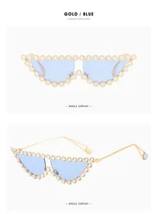 Detail of cat-eye sunglasses with gold metal frame and sparkling crystal embellishments