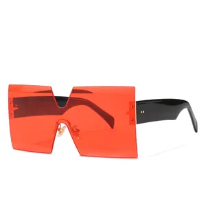 Oversized square shield sunglasses with bold red one-piece lens and chunky black temples