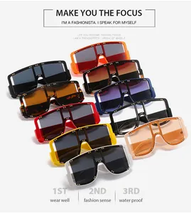 Close-up of oversized square sunglasses with gold rivet details in multiple colors