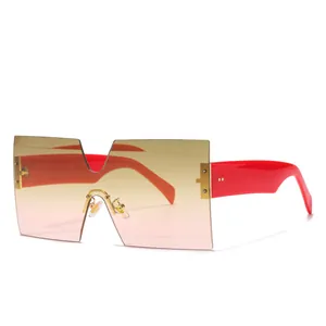Fashionable oversized square rimless sunglasses with pink gradient lenses and red temples