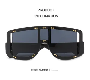 Detail view of black oversized shield sunglasses with gold metal rivet decorations