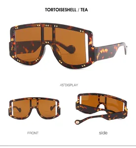 Detail view of large tortoiseshell sunglasses with tea lenses and golden rivet decor