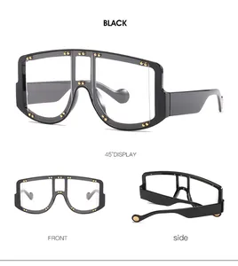 Detail of oversized flat top sunglasses featuring gold rivets and sleek black frames
