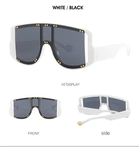 Detailed views of oversized white shield sunglasses with gold rivet accents on frame