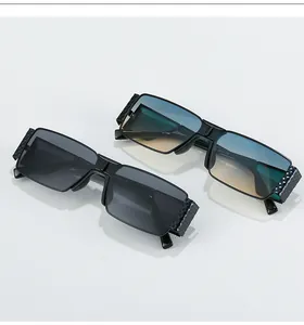 Detail of black rectangular sunglasses with textured temples and gradient lenses