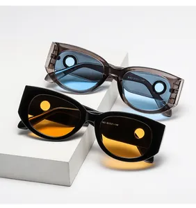 Detail view of oval cat-eye sunglasses with unique cutout holes on the lens edges