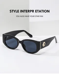 Detail of black oval sunglasses featuring a premium gold metal buckle on the sleek temple
