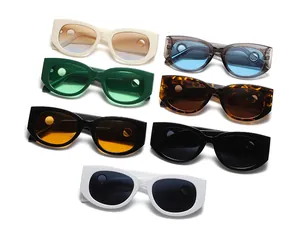 Various colors of oval sunglasses with unique circular side cut-outs and wide frames