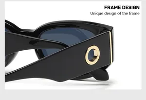 Close-up of black glossy temples with gold metal rings on oval fashion sunglasses