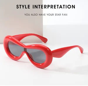 Macro shot of bright red oval one-piece fashion sunglasses with stylish dark gray lenses