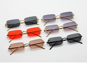 Detail view of colorful rimless rectangular sunglasses with gold and black metal temples