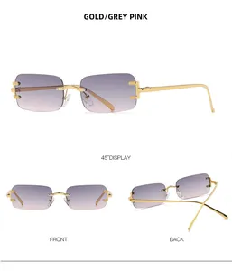 Detail of rimless square sunglasses with gold metal temples and gradient grey pink lenses