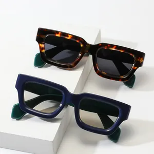 Retro rectangle sunglasses with tortoise frame and wide green temples displayed on props