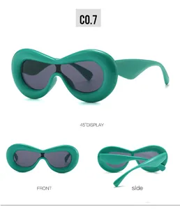 Three-angle view of oversized emerald green oval sunglasses with bold thick frames