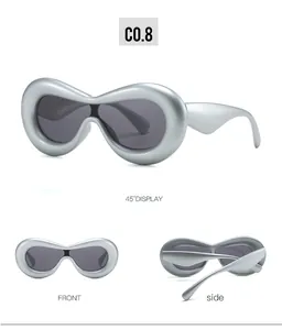 Three-way view of oval matte silver sunglasses with futuristic frames and dark lenses