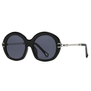 Vintage round frame sunglasses for women with thick black rims and metal hinges