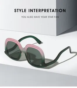 Detail showing oversized gradient pink and green sunglasses on white geometric blocks