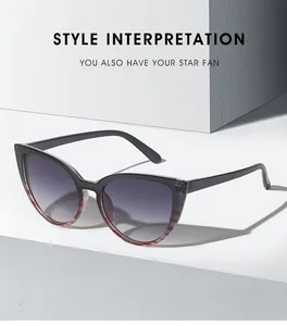 Detail of cat-eye sunglasses with red stripe accents and gradient lenses on a geometric stand