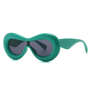 Fashionable green oval chunky sunglasses with dark grey lenses in a 45-degree side view