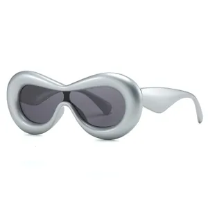 Futuristic Y2K oval silver oversized sunglasses with matte frame and dark grey lenses