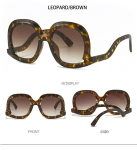 Detail of leopard print oversized sunglasses with brown gradient lenses and wavy arms