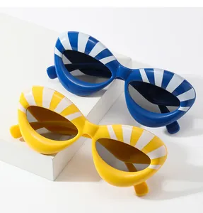 Detail of trendy thick-framed cat-eye sunglasses with blue and yellow striped patterns