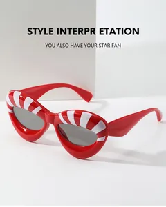 Detail of red cat-eye sunglasses with white stripes and retro fashion design