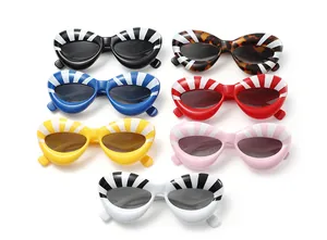 Flat lay of colorful cat-eye sunglasses with thick frames and radial stripe patterns