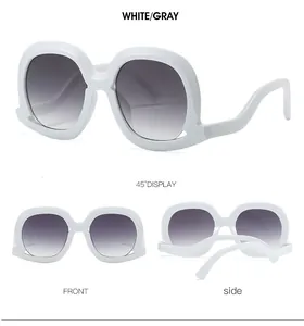 Detail view of retro oversized white sunglasses with wave-shaped temples and gray lenses