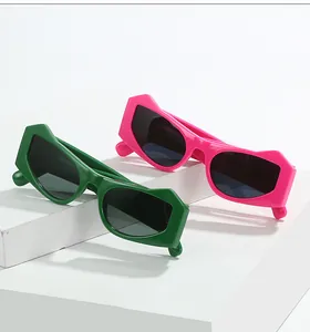 Close-up of pink and green cat eye sunglasses with sharp geometric frames on white stairs