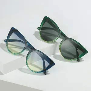 Fashionable cat-eye sunglasses for women with gradient frames on a white pedestal