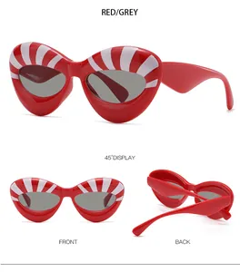 Detail view of red cat-eye sunglasses with white stripes from multiple angles