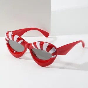 Retro cat-eye sunglasses with red frames and white radial stripes on white background