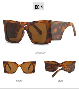 Viste dettagliate degli occhiali da sole cat eye leopardati con lenti marroni
