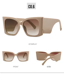 Dettagli di occhiali da sole cat-eye beige con aste larghe e lenti sfumate marroni