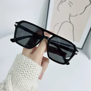 Classic square black sunglasses with dark grey lenses and silver metal hinges detail