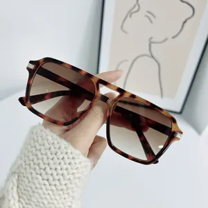 Fashionable tortoise shell square sunglasses with gradient brown lenses and metal accents